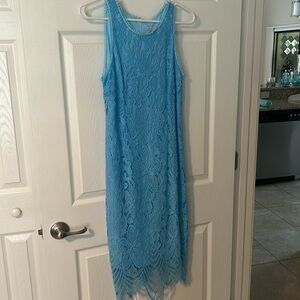 A sleeveless aqua mid length lace dress it was worn to a wedding once.